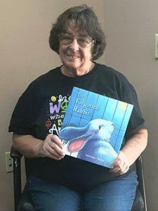 Lynn Hildebrand holding The Forgotten Rabbit book