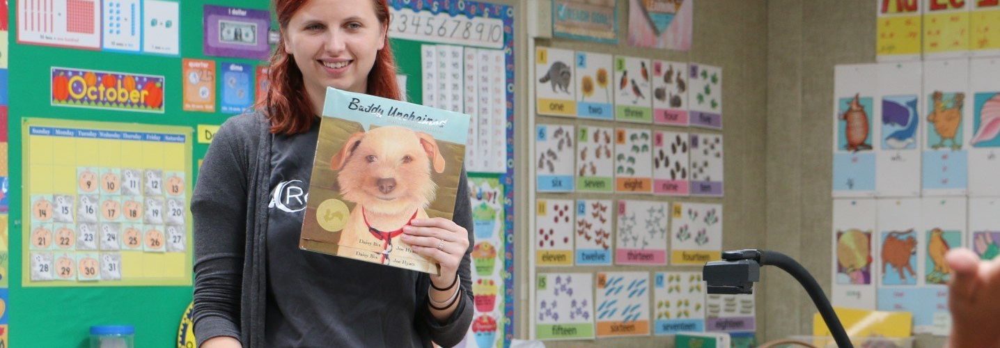 Teacher holding book in classroom