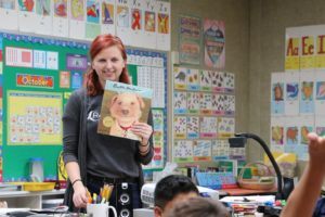 Teacher holding book in classroom