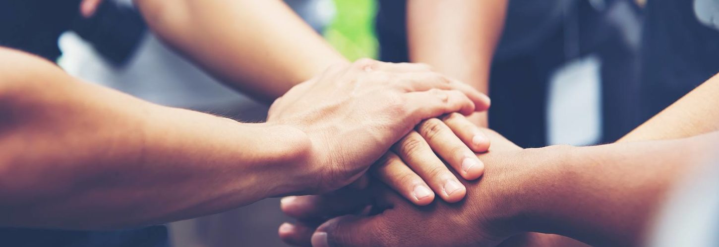 Group of hands uniting together in a circle