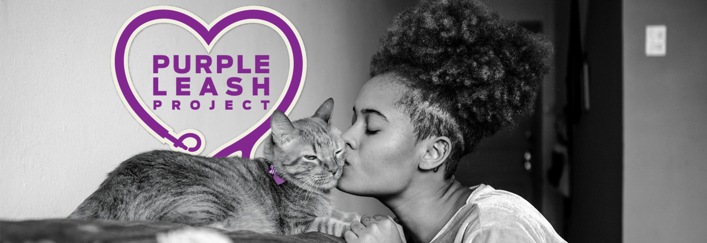 Purple Leash Project Header: Black and white photo of a woman kissing her cat on a bed