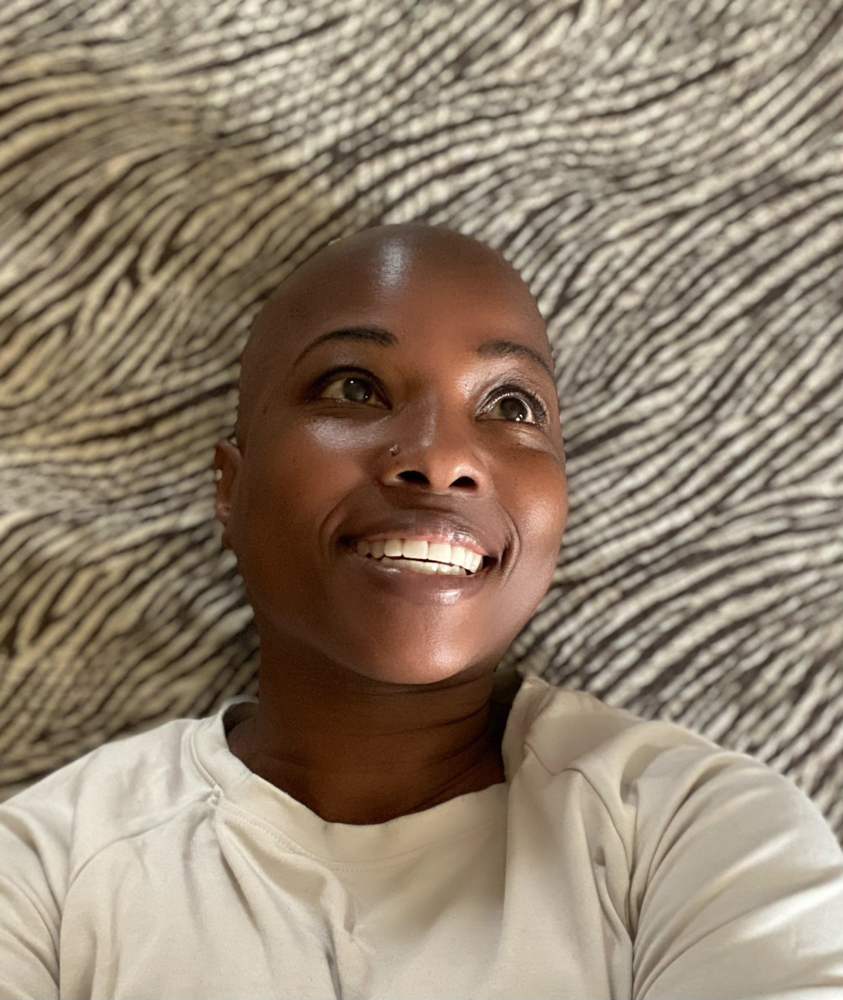 Selfie of Dr. Duncan, a black woman, smiling while looking off to the right of the camera