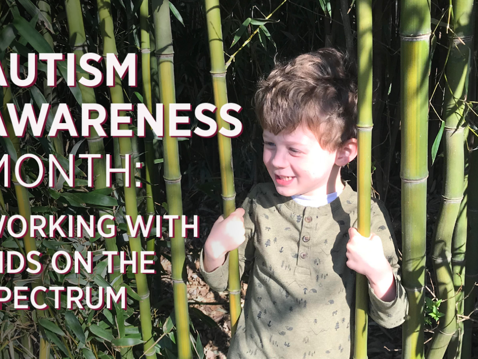 A young boy smiles in a field of bamboo. Text reads Autism Awareness Month: Working with kids on the spectrum