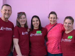 group of RedRover Responders volunteers posing in front of a pink wall