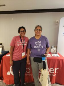 two women wearing RedRover apparel at the National Organization for Victim Advocacy conference