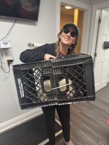 RedRover Responders Team Lead Devon Krusko holds a Himalayan cat who was dropped off in a milk crate