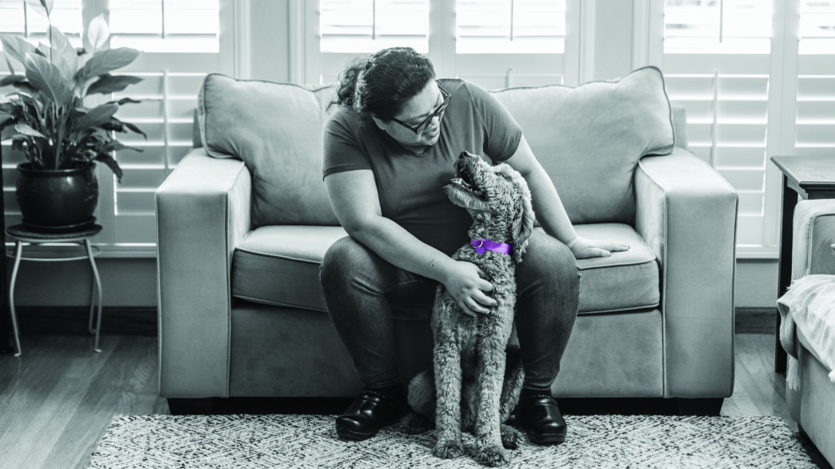 RedRover and Purina's Purple Leash Project - person and dog with purple collar embrace