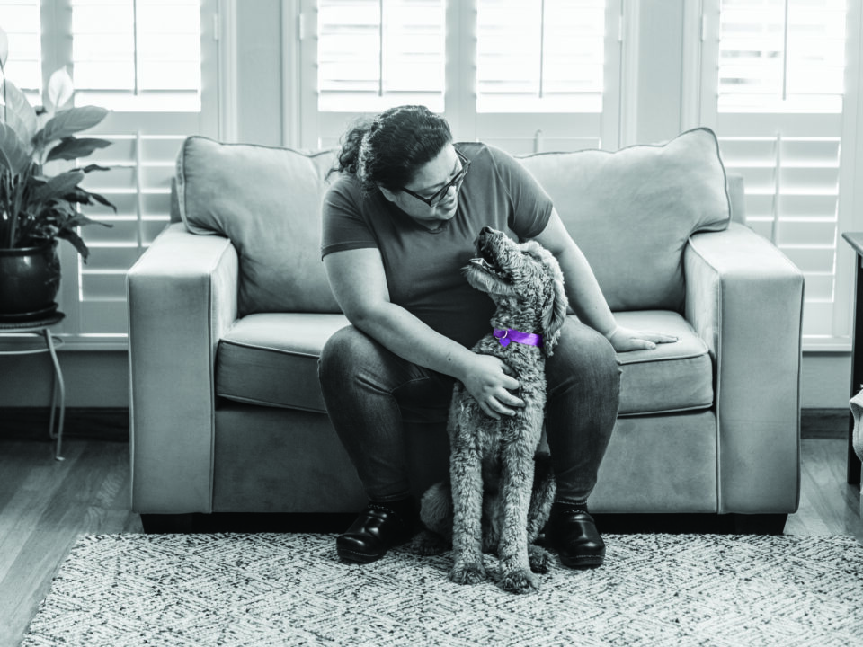 RedRover and Purina's Purple Leash Project - person and dog with purple collar embrace
