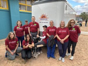 volunteers and staff pose in front of a truck during a deployment with the RedRover Responders team and Underdog - Moab