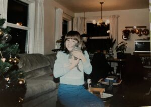 RedRover Director of Development Erin Bialecki cuddles with a kitten as a child