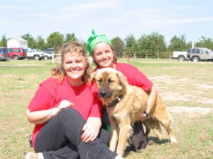 RedRover Responders volunteer comforts a dog at Hurricane Katrina