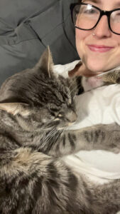 RedRover Happy Tails - Dusty the cat cuddling with his parent
