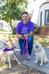RedRover President and CEO Katie Campbell poses with two dogs