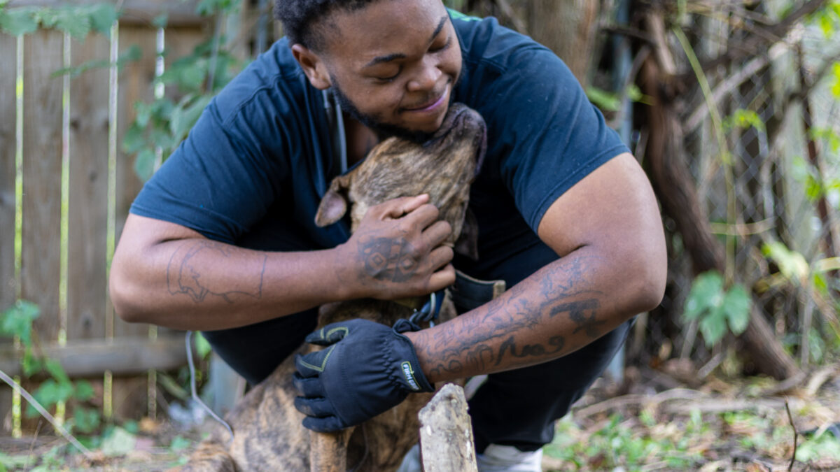 RedRover Responders deployment - Detroit Dog Aide - pet parent hugs his dog