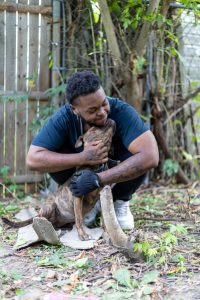RedRover Responders deployment - Detroit Dog Aide - pet parent hugs his dog