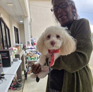 PAWS NE LA pet family, a white dog and senior woman