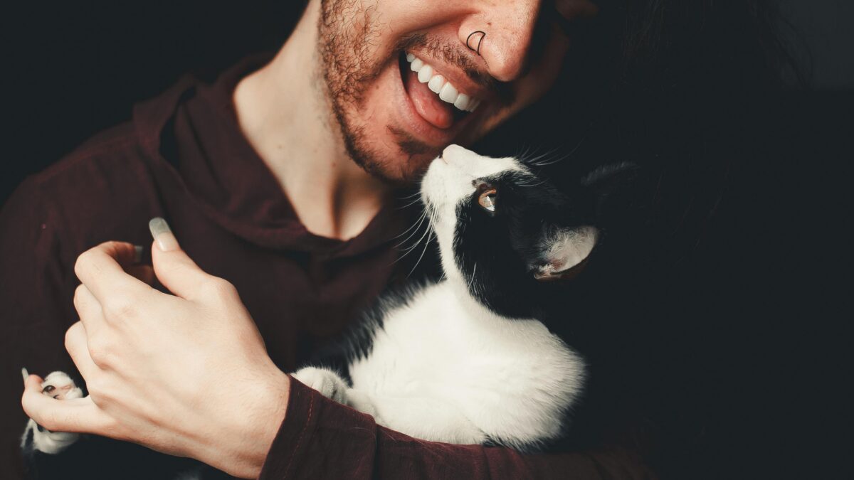 Nonbinary person holding a cat