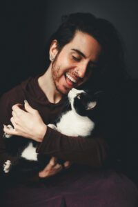 Nonbinary person holding a cat