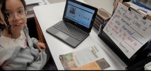 Penelope in Ms. Ramos' classroom reads Kind News and hosts a radio show