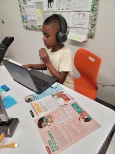 Eli in Ms. Ramos' classroom reads Kind News and hosts a radio show