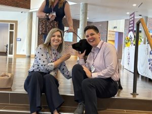 RedRover President and CEO Katie Campbell with a dog and colleagues at NJCEDV