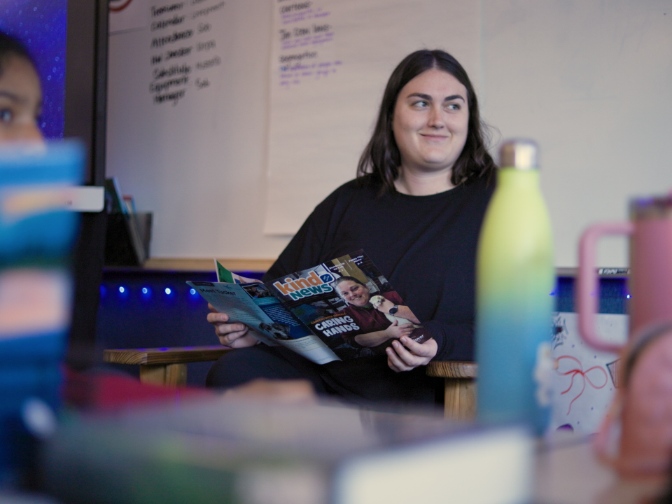 A teacher at Northlake Elementary in Sacramento holds Kind News magazine