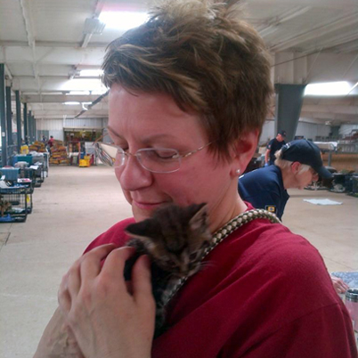 RedRover Responders volunteer Team Leader Donna Lagomarsino cuddles a kitten at the City of Moore's temporary emergency shelter.